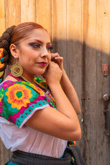 Portrait of a Mexican woman wearing a traditional dress for folk dance