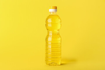 Bottle of sunflower oil on yellow background