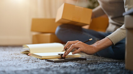 Female online shop owner packing her customer's order. cropped, close-up image