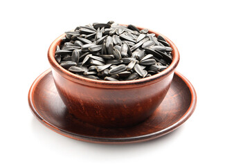Unpeeled sunflower seeds in bowl on white background