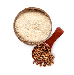 Bowl of flour and spoon with buckwheat grains on white background