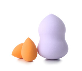 Different make up sponges on white background