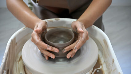 Cropped, Woman's hands molding clay, making a clay pottery in the workshop.