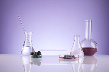 Front view of blueberry extract decorated with transparent podium and glassware blank space in purple background	