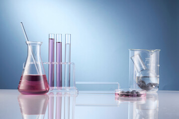 Front view of blueberry extract decorated with transparent podium and glassware blank space in blue...