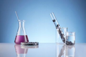 Front view of blueberry extract decorated with transparent podium and glassware blank space in blue...