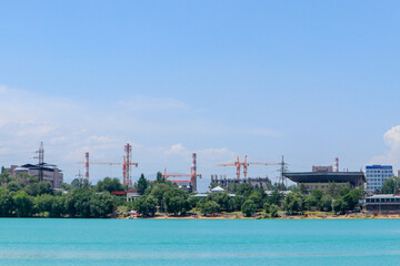 construction cranes on the background of water