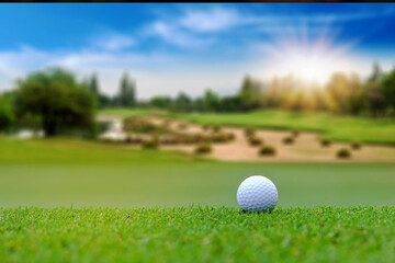 White Golf ball on green course to be shot on blurred beautiful landscape of golf course in bright day time with copy space. Sport, Recreation, Relax in holiday concept	