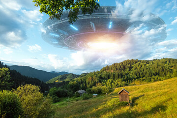 UFO, an alien saucer hovering over the mountains in the clouds, hovering motionless in the sky....