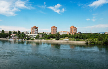 Fototapeta na wymiar View of the city of Ust-Kamenogorsk (kazakhstan). Old residential area. Soviet built multistory apartment buildings. Irtysh river. Green trees and blue sky