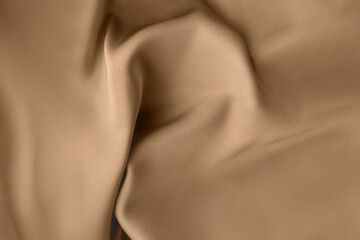 Creased Luxury light brown beige color with smooth satin silk cloth texture decorate background with minimalistic style and space