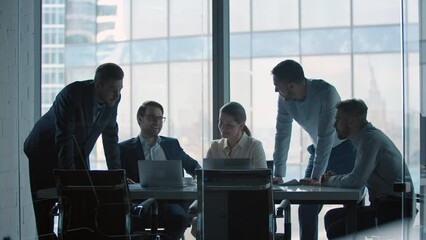 Group of business people working at a table at meeting room. Mature business people working with laptop - Powered by Adobe