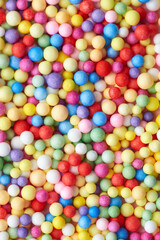 Fototapeta na wymiar Small multicolored polyfoam balls, theme of holidays and birthdays.