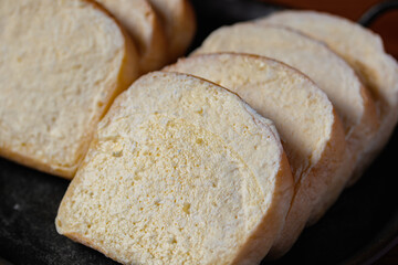 brown buttered bread on wooden background