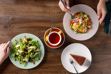 Overhead view of food on table with two people