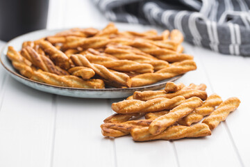 Salted pretzel sticks. Salted crackers on plate.