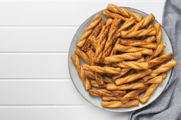 Salted pretzel sticks. Salted crackers on plate.