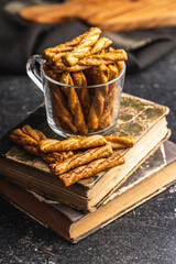 Salted pretzel sticks. Salted crackers on black table.