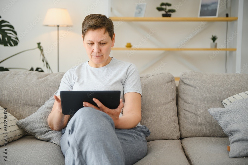 Canvas Prints people, technology and internet concept - happy middle aged woman with tablet pc computer at home.