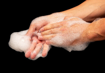 foam on hands when washing hands on black background