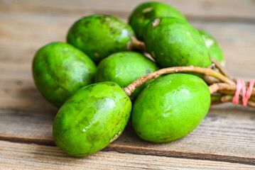 Fruit of Elaeocarpus hygrophilus on wooden background , Spondias mombin