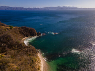 Obraz premium Beautiful aerial view of Costa Rica Beach Playa Rajada in Cuajiniquil Guanacaste in magical yellow sunset
