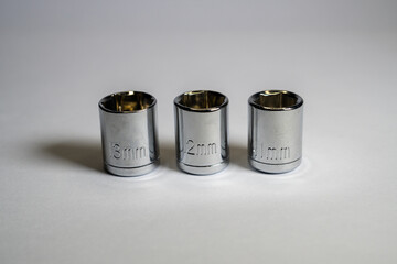 Wrenches with sizes 11mm, 12mm and 13mm. Wrenches of various sizes on white background and isolated focus. Wrench socket. Drive socket.