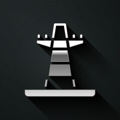 Silver Electric tower used to support an overhead power line icon isolated on black background. High voltage power pole line. Long shadow style. Vector