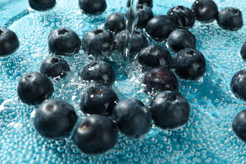 Concept of fresh summer fruits, blueberry in water
