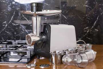 soft focus. electric meat grinder its components lie side by side. close-up.