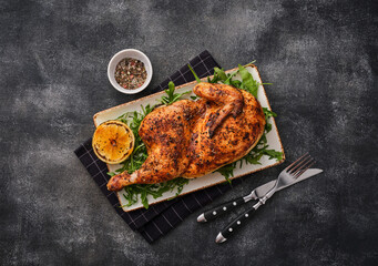 Grilled chicken. A half baked chicken with lemon and spices baked in the oven. Delicious juicy chicken. Grilled poultry - 512277719