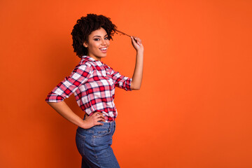 Profile photo of positive nice person hand play hold hair curl isolated on orange color background