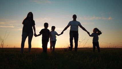 Fototapeta na wymiar people in the park silhouette. happy lifestyle family kid dream holiday concept. friendly family holding hands a walking the dog at sunset in the park silhouette . big family silhouette walk in the