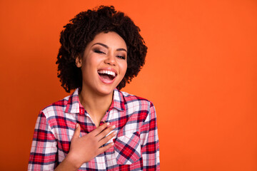 Photo of funny sweet woman wear plaid shirt arm chest smiling laughing isolated orange color background