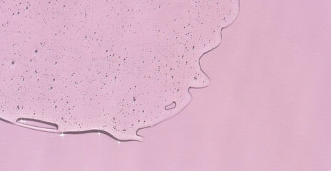 Transparent hyaluronic gel or serum on a pink background. Skincare cosmetics product. Wellness and beauty concept. Top view