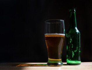 glass of beer and green bottle