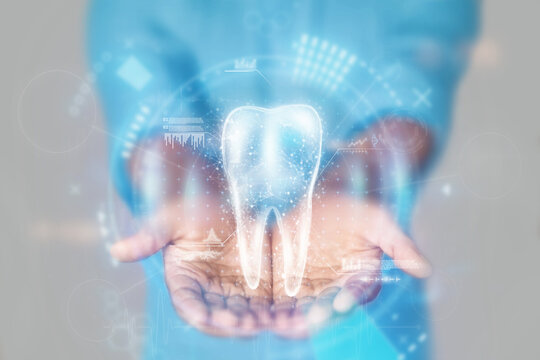 Medical concept, doctor's hands in a blue coat close-up and tooth hologram. X-ray of the jaw, ultrasound. Medical care, anatomy, dentist appointment. mixed media