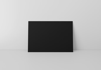 Empty black horizontal rectangle A4 paper sheet mockup on floor over grey wall, 3D rendering