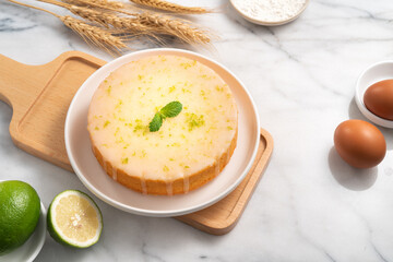 Delicious Lemon Glazed Pound Sponge cake on white marble table background.