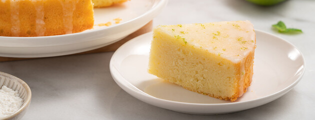 Delicious Lemon Glazed Pound Sponge cake on white marble table background.