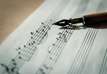 Music sheet, sheet music and feather, concept of composing music, music background - obrazy, fototapety, plakaty