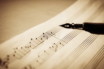 Foto op Plexiglas Music sheet, sheet music and feather, concept of composing music, music background © Liiiz