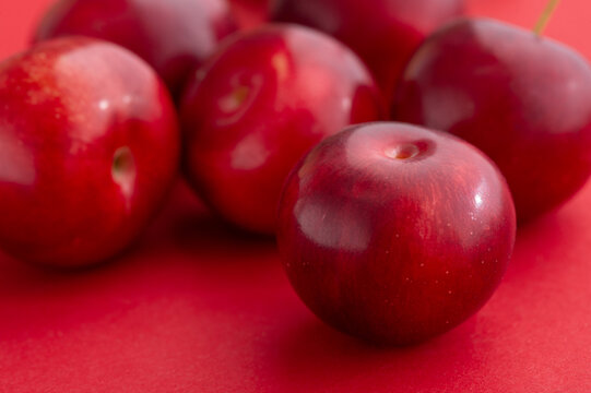 Plums are on a red background.