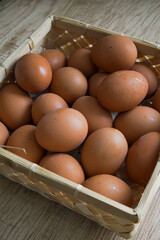 chicken eggs in a wooden basket
