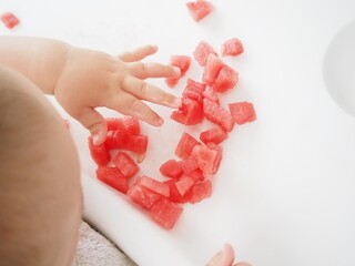 manos de beb&eacute; tocando y comiendo sand&iacute;a