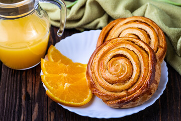 A cup of black tea and a plate with homemade bakery, biscuit on a wooden table. Close-up.