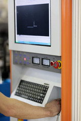 operator controls CNC metal cutting machine