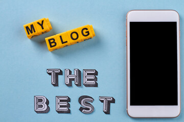 Flat lay my blog the best concept. Smartphone on blue background.