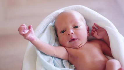 newborn. baby newborn a close-up lies looking at the camera in the hospital maternity hospital. happy family baby dream concept. lifestyle cute newborn baby wrapped in a blanket