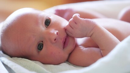 newborn. baby newborn a close-up lies looking lifestyle at the camera in the hospital maternity hospital. happy family baby dream concept. cute newborn baby wrapped in a blanket